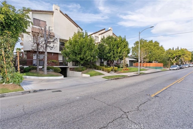 view of street with curbs, sidewalks, and street lights