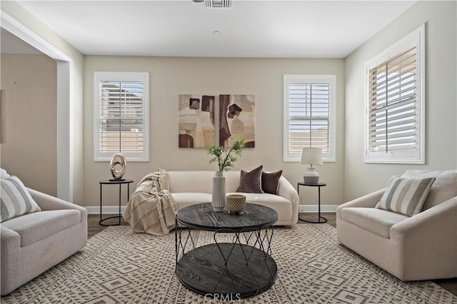 living room featuring a wealth of natural light and baseboards