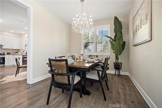 dining room with baseboards, a chandelier, wood finished floors, and recessed lighting