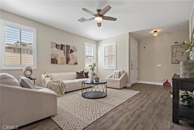 living area with ceiling fan, visible vents, baseboards, and wood finished floors