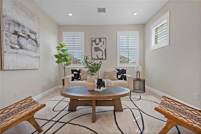 living area featuring recessed lighting, visible vents, light carpet, and baseboards