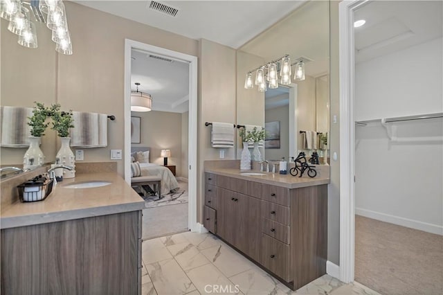 full bath featuring marble finish floor, visible vents, a sink, and ensuite bathroom