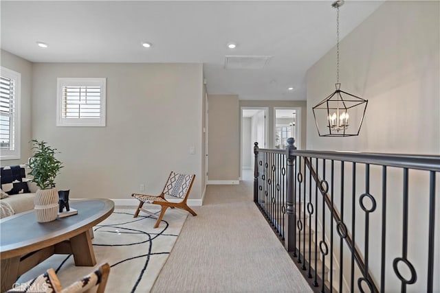 living area with baseboards, light colored carpet, an upstairs landing, a chandelier, and recessed lighting