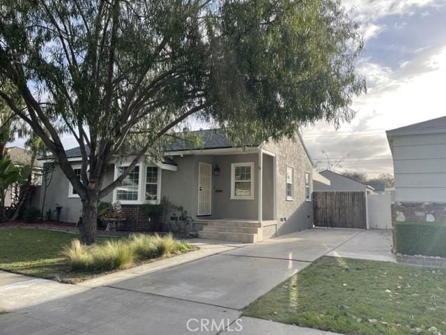 view of front facade featuring concrete driveway and stucco siding