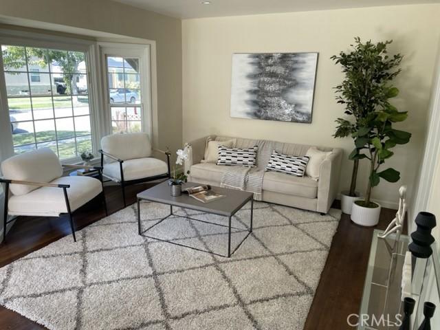 living area with wood finished floors and baseboards