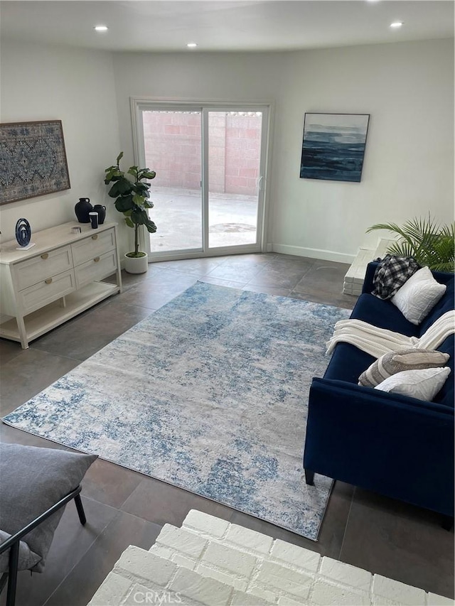 living room with baseboards and recessed lighting