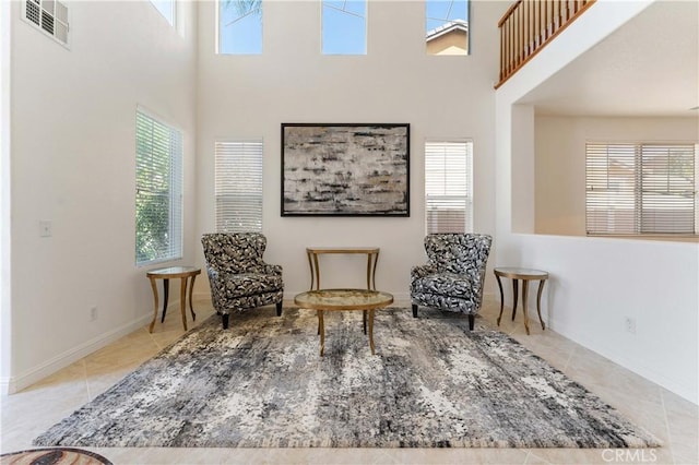 sitting room featuring plenty of natural light, visible vents, and tile patterned flooring