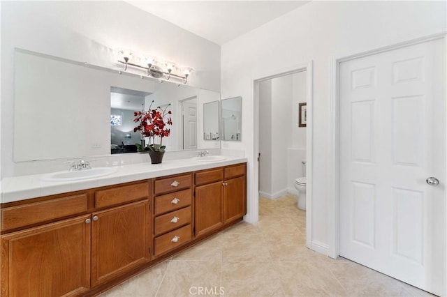 full bathroom with tile patterned flooring, a sink, toilet, and double vanity