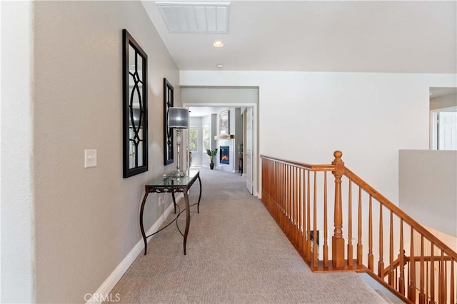 corridor featuring recessed lighting, visible vents, carpet flooring, an upstairs landing, and baseboards