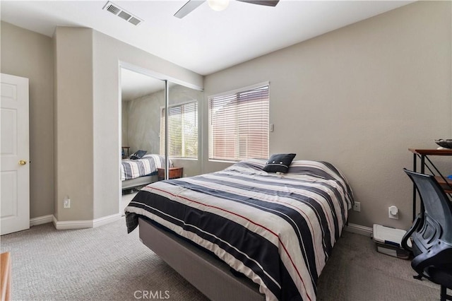 carpeted bedroom with ceiling fan, a closet, visible vents, and baseboards