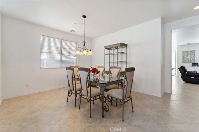 dining area featuring a chandelier, baseboards, and light tile patterned floors