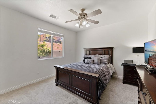 bedroom featuring a ceiling fan, light colored carpet, visible vents, and baseboards