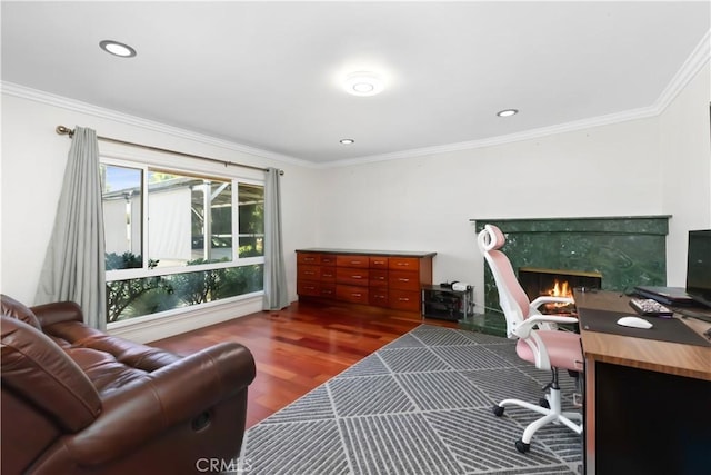 office space featuring ornamental molding, recessed lighting, a fireplace, and wood finished floors