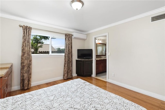 unfurnished bedroom with a wall unit AC, wood finished floors, visible vents, baseboards, and ornamental molding