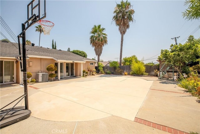 view of basketball court with fence