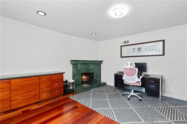 home office featuring a premium fireplace, visible vents, and ornamental molding