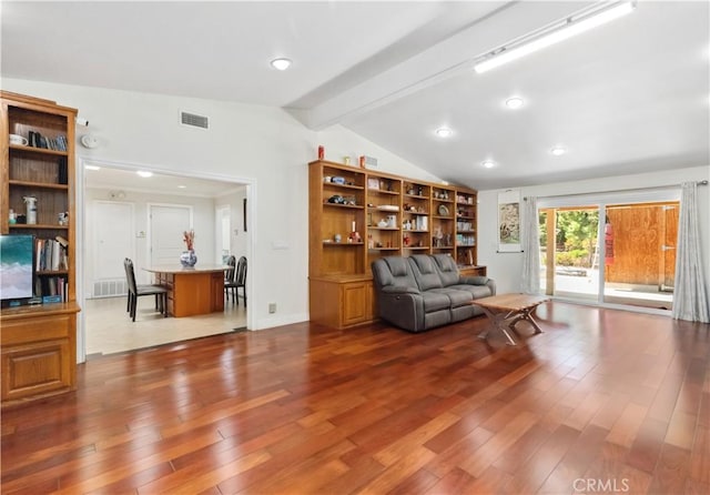 living room with lofted ceiling with beams, wood finished floors, visible vents, and baseboards