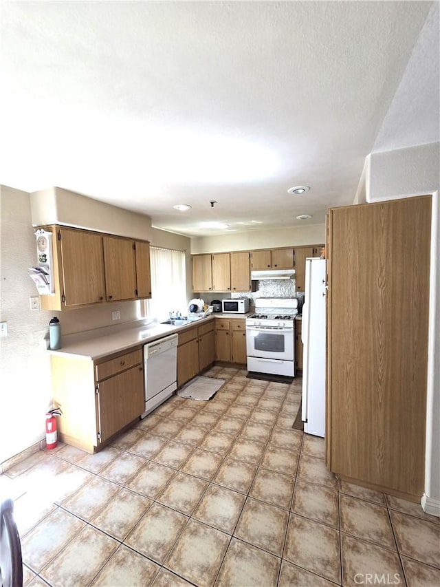 9146 Tobias Ave Unit 3, Panorama City, CA 91402 - kitchen featuring white appliances, a sink, under cabinet range hood, light countertops, and recessed lighting