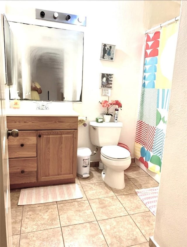 9146 Tobias Ave Unit 3, Panorama City, CA 91402 - bathroom featuring toilet, vanity, tile patterned flooring, and a shower with shower curtain