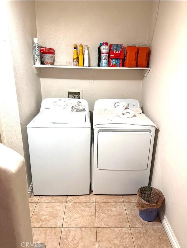 9146 Tobias Ave Unit 3, Panorama City, CA 91402 - washroom with washer and clothes dryer and light tile patterned flooring