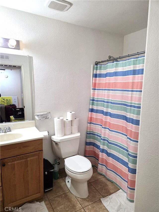 9146 Tobias Ave Unit 3, Panorama City, CA 91402 - bathroom with vanity, toilet, tile patterned floors, a shower with shower curtain, and a textured wall