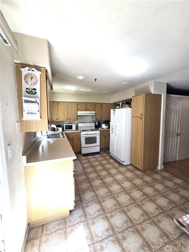 9146 Tobias Ave Unit 3, Panorama City, CA 91402 - kitchen with white appliances, light countertops, under cabinet range hood, and a sink