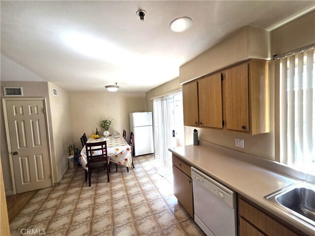 9146 Tobias Ave Unit 3, Panorama City, CA 91402 - kitchen with white appliances, light countertops, a sink, light flooring, and brown cabinets