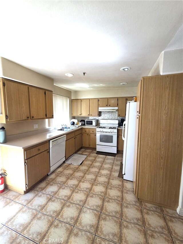 9146 Tobias Ave Unit 3, Panorama City, CA 91402 - kitchen with white appliances, under cabinet range hood, a sink, light countertops, and recessed lighting