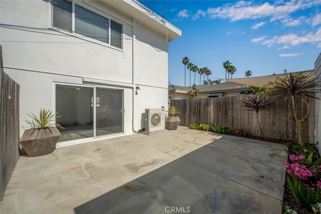 view of patio / terrace featuring ac unit and fence