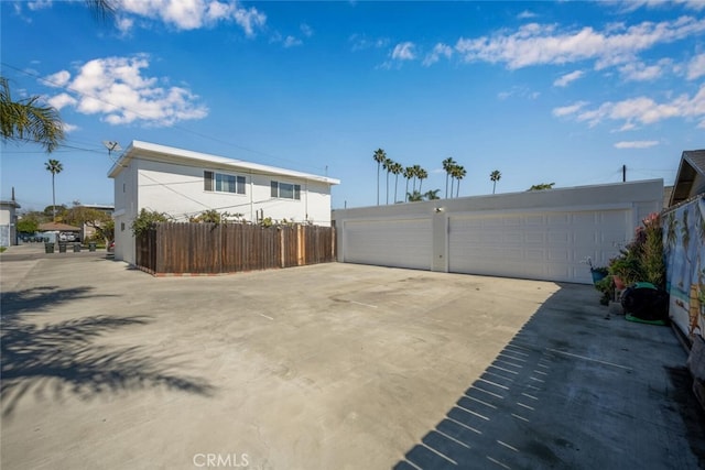 exterior space with an outbuilding, fence, and a detached garage