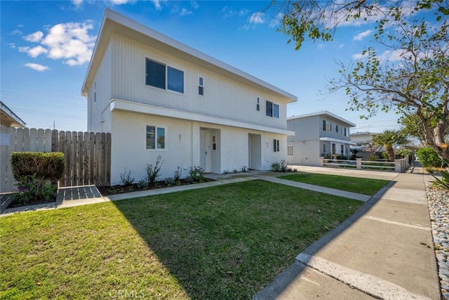 view of front of property with a front yard and fence