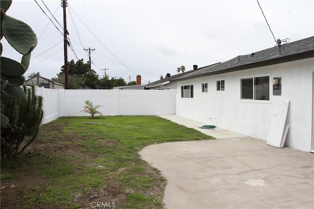 view of yard with a patio area and a fenced backyard