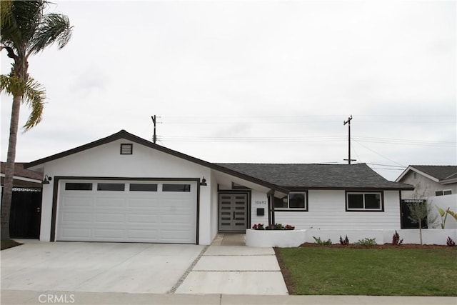 ranch-style home with a garage, a front yard, driveway, and fence