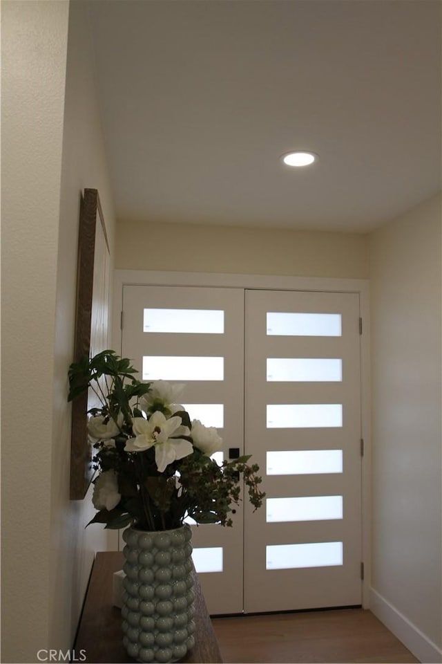 doorway featuring recessed lighting, baseboards, wood finished floors, and french doors