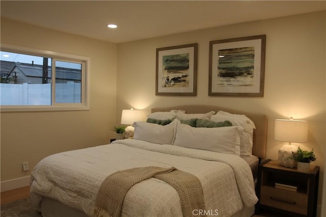 bedroom with recessed lighting, baseboards, and wood finished floors