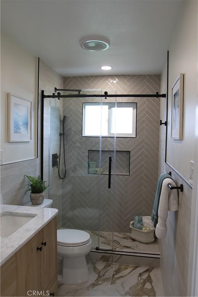 bathroom featuring a shower stall, tile walls, toilet, and marble finish floor