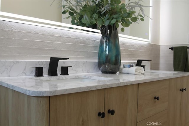 details featuring double vanity and a sink