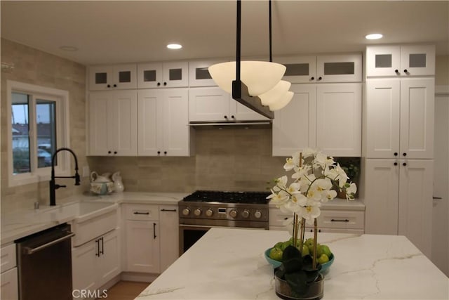 kitchen with light stone countertops, gas range, white cabinetry, and dishwasher