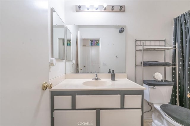 bathroom featuring vanity and toilet