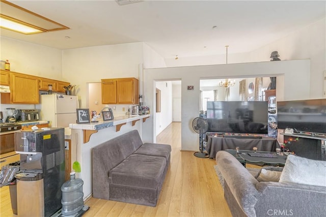 living room with a notable chandelier and light wood-style floors