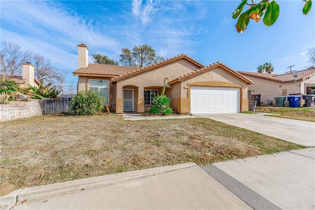 mediterranean / spanish house featuring a chimney, stucco siding, an attached garage, driveway, and a tiled roof