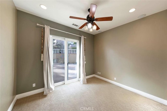 empty room featuring carpet floors, visible vents, and baseboards