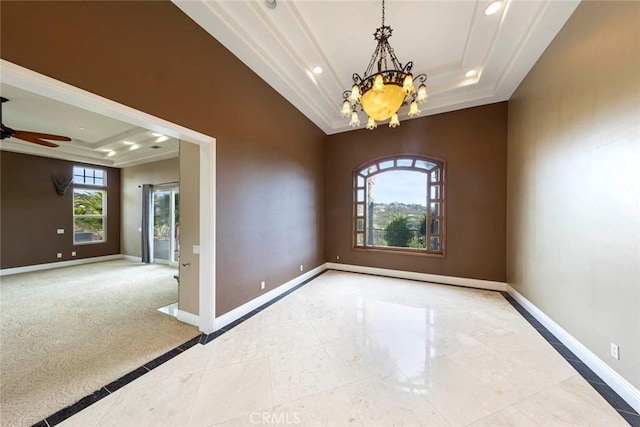 empty room with a raised ceiling, baseboards, and ceiling fan with notable chandelier