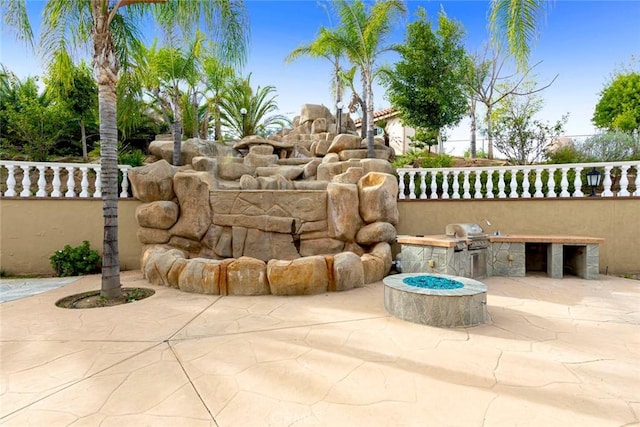 view of patio featuring fence, grilling area, and area for grilling