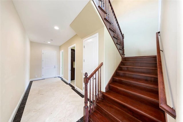 stairway with recessed lighting and baseboards