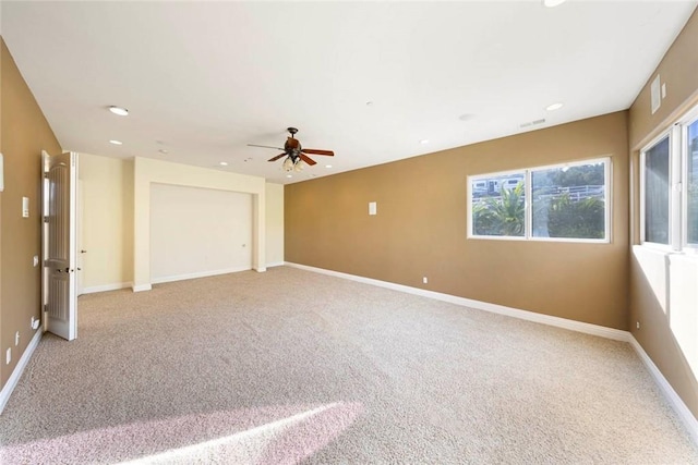 spare room featuring light carpet, recessed lighting, visible vents, and baseboards