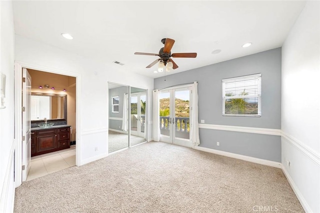 unfurnished bedroom with access to exterior, french doors, light colored carpet, visible vents, and baseboards