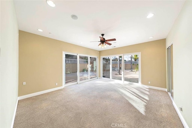 empty room featuring carpet floors, recessed lighting, a ceiling fan, and baseboards