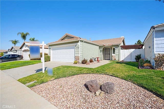 ranch-style home featuring stucco siding, driveway, fence, a front yard, and an attached garage