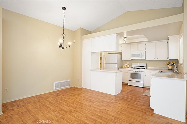 kitchen with visible vents, a sink, white appliances, light wood-style floors, and light countertops